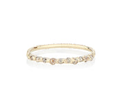 grey champagne and cognac rose cut diamonds are hand set and cast in place on this dainty sparkler of a stackable ring made by model jayne moore jeweler writer jayne moore in her new york studio using recycled gold and certified conflict free diamonds rebel set unconventional ring setting dainty engagement ring cast not set #castnotset