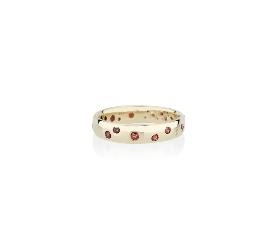 Rubies sunk in to recycled gold in model and jewelry designer Jayne Moore's signature style handmade in New York city using recycled metals freestyle stone setting confetti ring rubies garnets sapphires diamonds