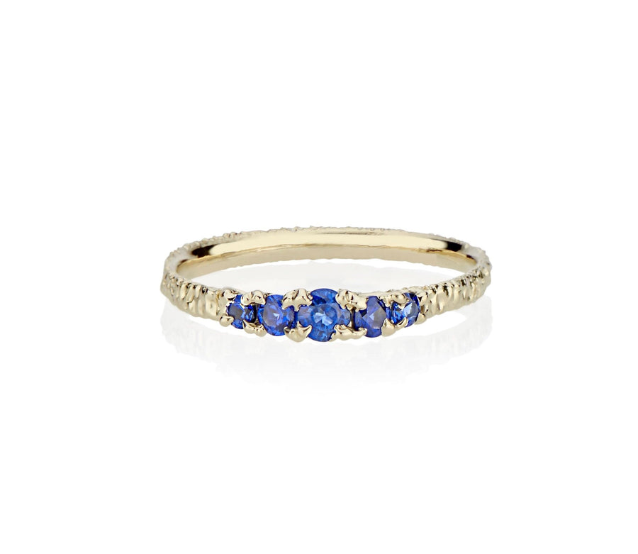 A modern take on victorian style jewelry in this five sapphire ring stack made in nyc by model jayne moore jewelry designer jayne moore from recycled metal royal blue sapphires cast not set cast in place rebel set 