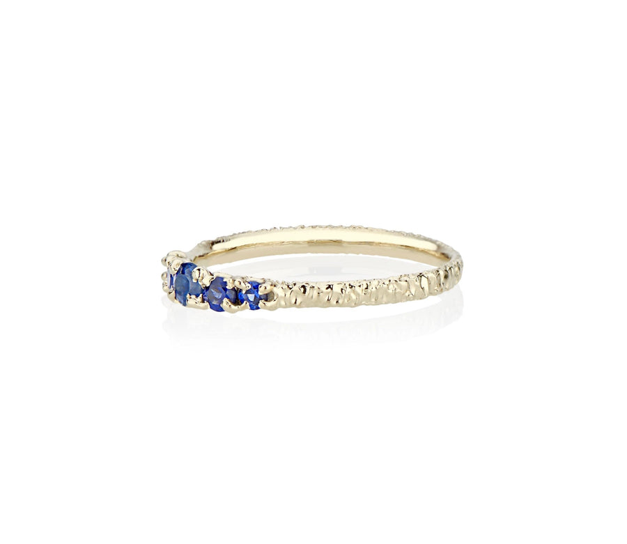 A modern take on victorian style jewelry in this five sapphire ring stack made in nyc by model jayne moore jewelry designer jayne moore from recycled metal royal blue sapphires cast not set cast in place rebel set 