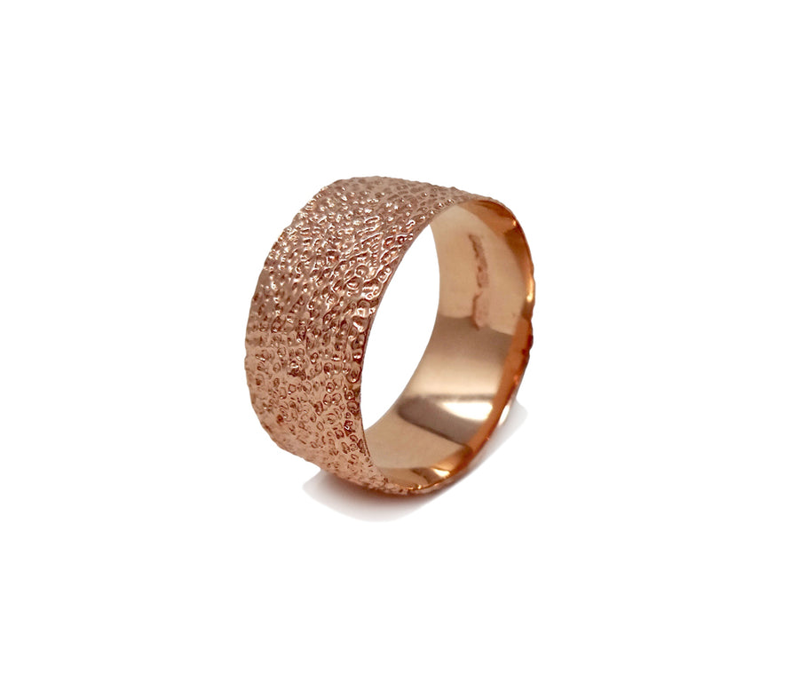 Simple elegant broad ring bands hand textured to emulate the dappled light naturally found in nature handmade in NYC by designer Jayne Moore model Jayne Moore from recycled refined metals in 18kt gold a light classic timeless wedding band for him or for her 18kt rose gold