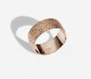 Simple elegant broad ring bands hand textured to emulate the dappled light naturally found in nature handmade in NYC by designer Jayne Moore model Jayne Moore from recycled refined metals in 18kt gold a light classic timeless wedding band for him or for her 
